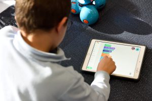 A kid solving a puzzle on his tablet