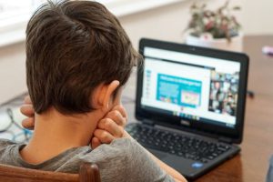 Boy taking online tutoring sessions.