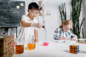 kids doing experiments during live online science tutoring.