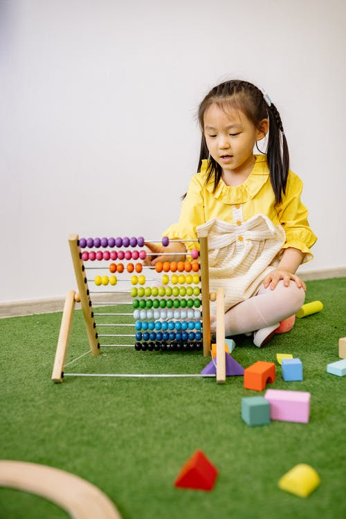 girl learning to count with an abacus